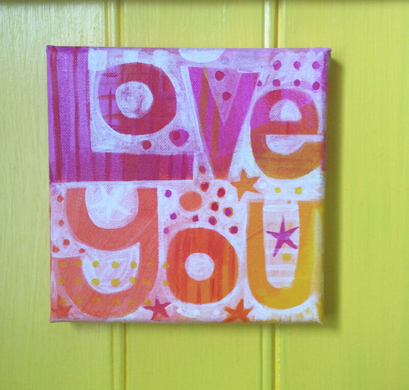 Asquare canvas painting that says Love You in pinks oranges and yellow, by Jo Brown.